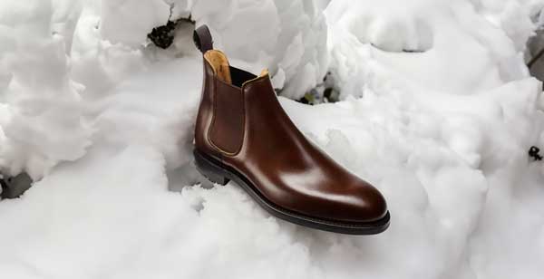 Brown Chelsea boot in snow for winter menswear